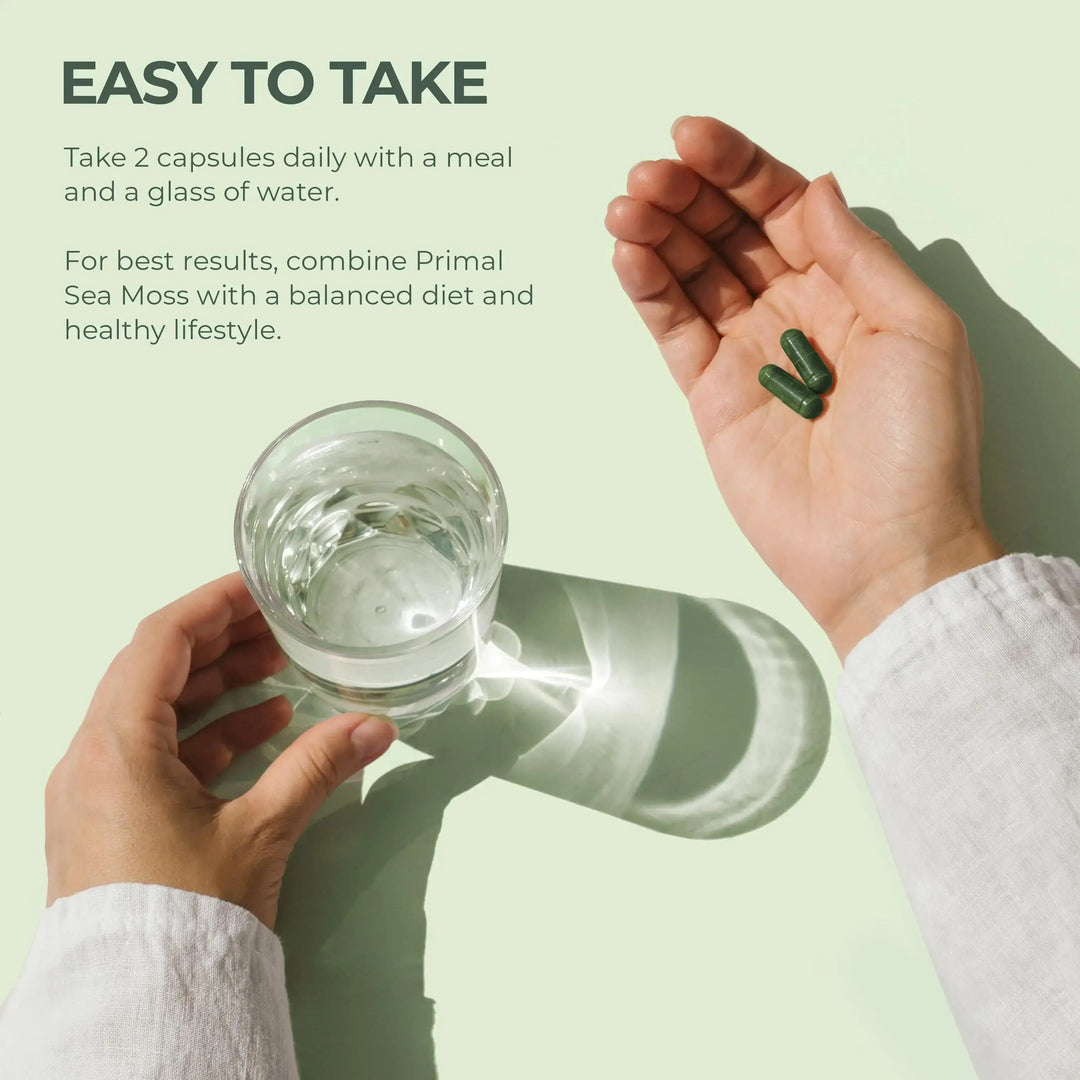 Hand holding a glass of water and capsules with text on a light green background